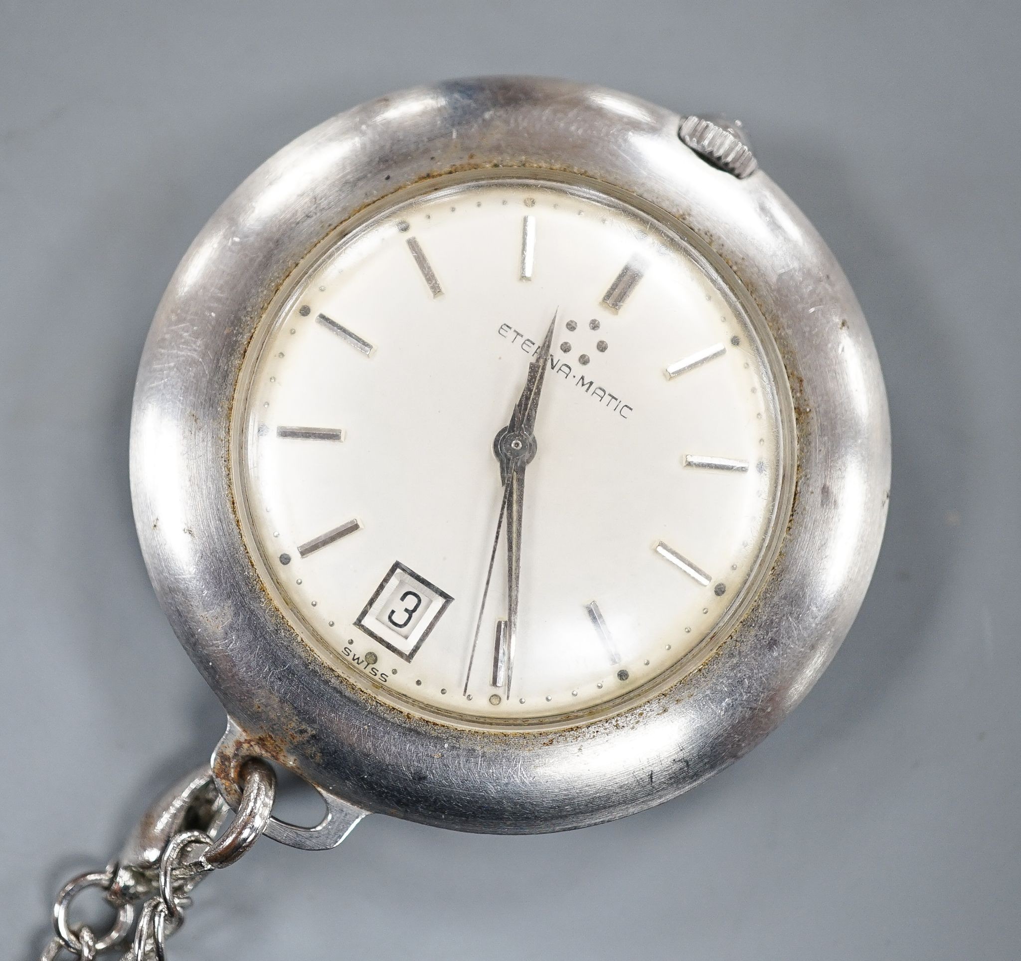 A base metal cased Eterna-matic manual wind dress pocket watch, with date aperture, on a metal chain.